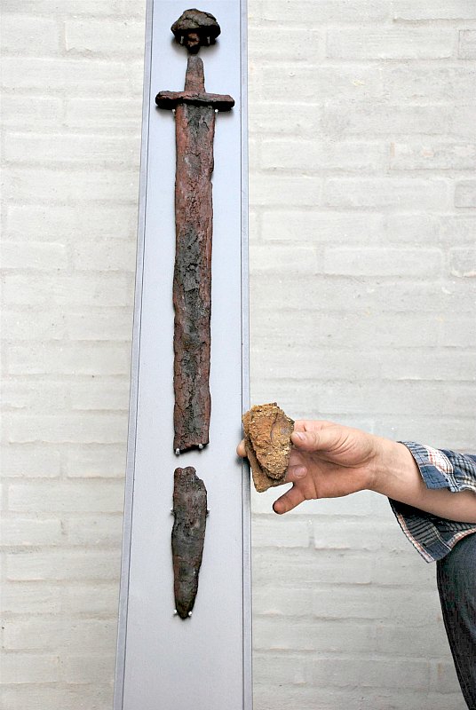 Durante la nueva excavación de la tumba apareció una pieza de diez centímetros de la espada del guerrero vikingo, lo que demuestra que la espada medía más de noventa centímetros de largo. (Fotografía: National Geographic)