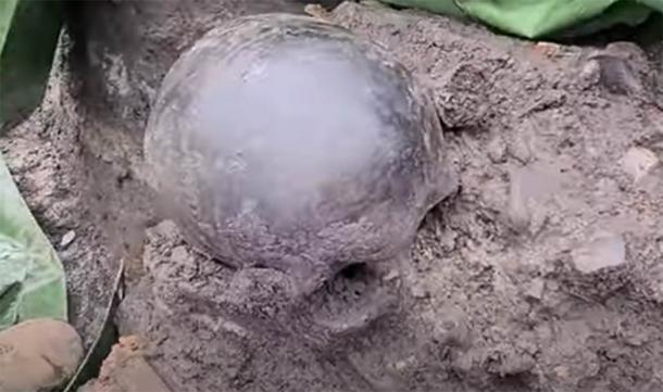 Uno de los cráneos que se encontró en el lugar, ennegrecido, presumiblemente por la quema. (Bochnianin / Youtube)